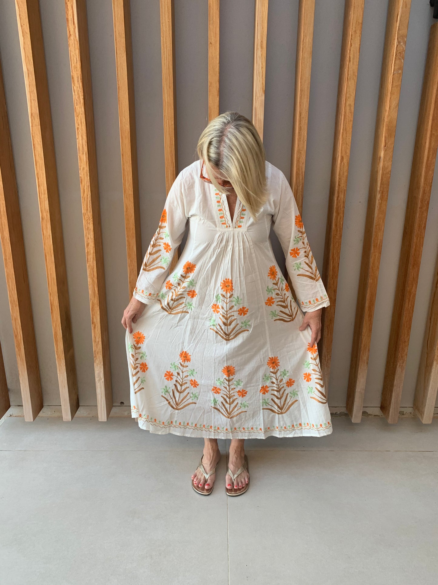White dress with embroidered Orange & Green floral pattern