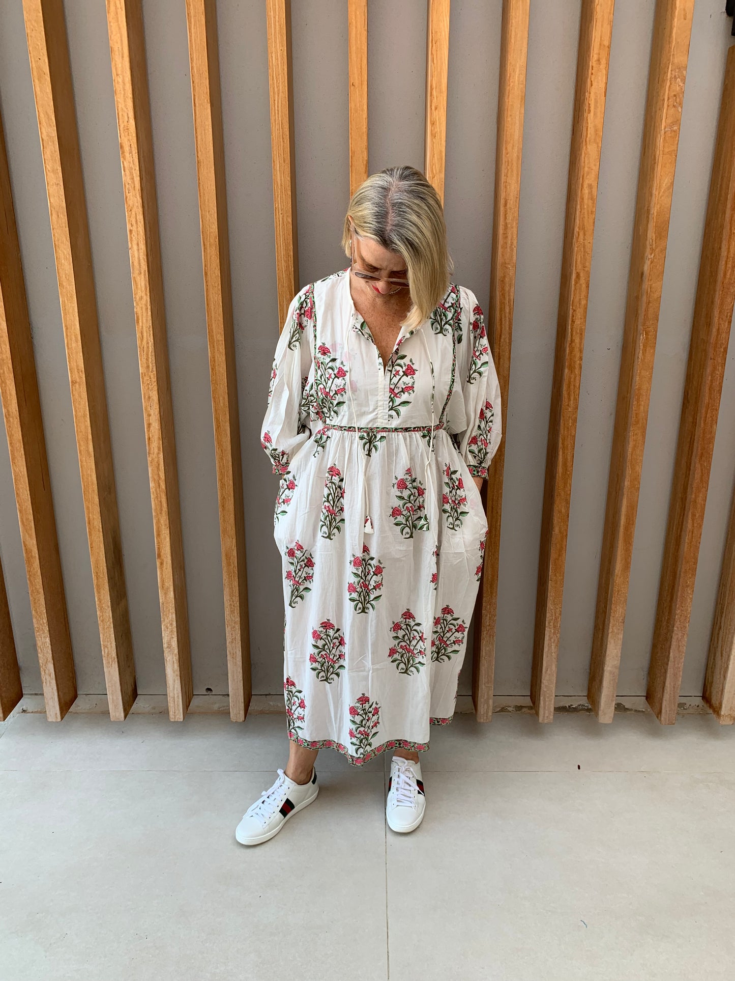 White dress with red rosebush floral pattern