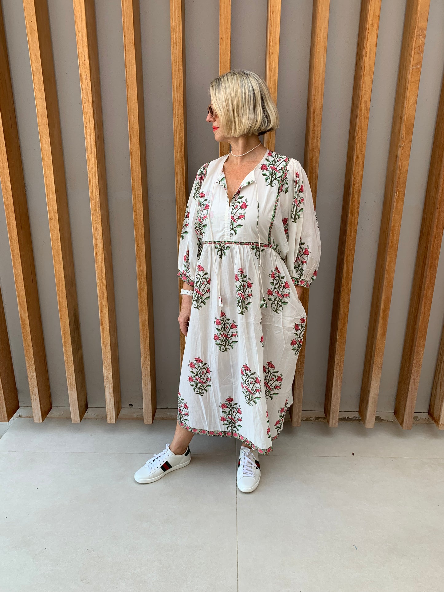 White dress with red rosebush floral pattern