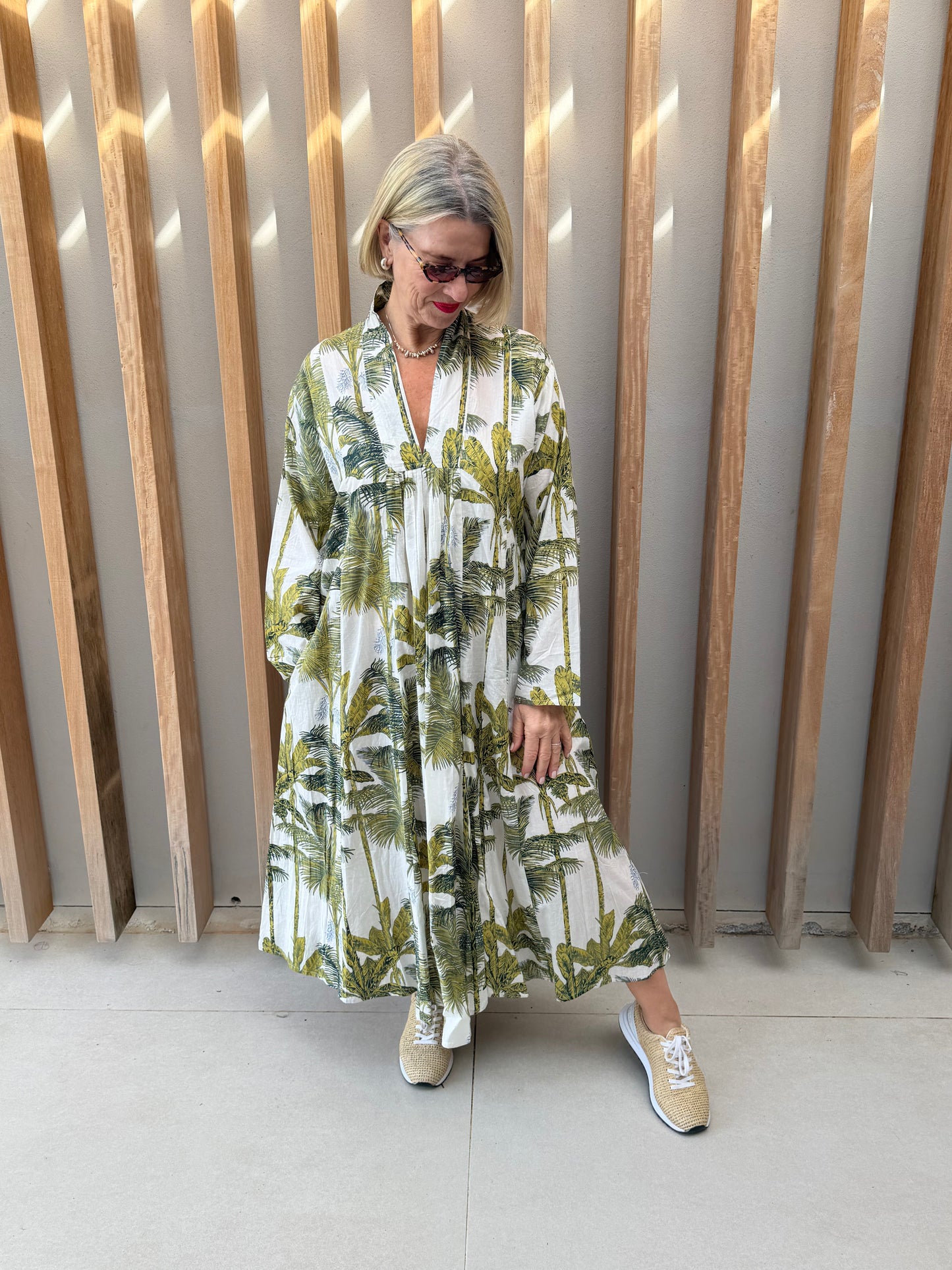 White dress with green floral palm pattern